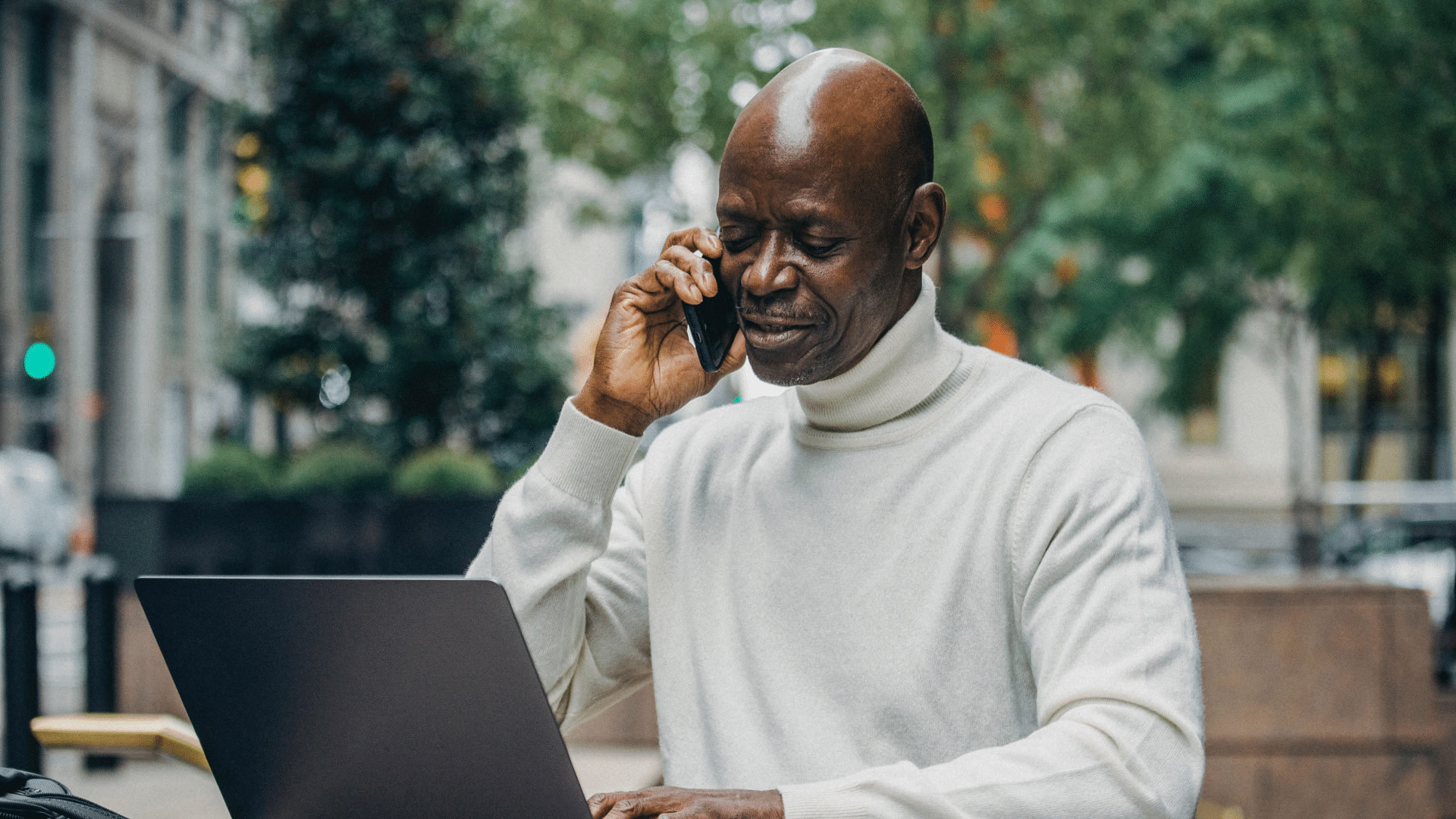 Man on the phone and on his laptop